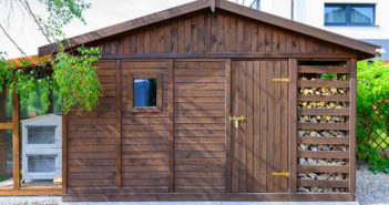 Garden shed exterior in Spring, with woodshed