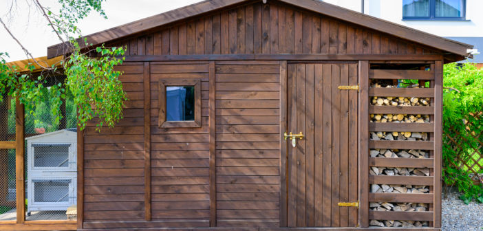 Garden shed exterior in Spring, with woodshed
